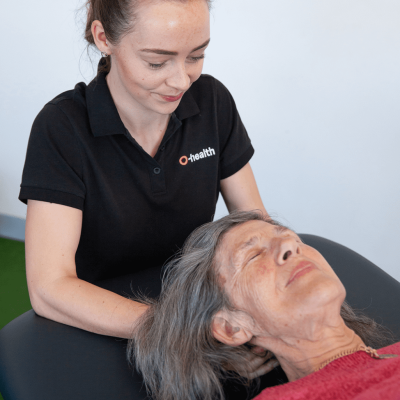 One of our therapists, treating a patients neck.